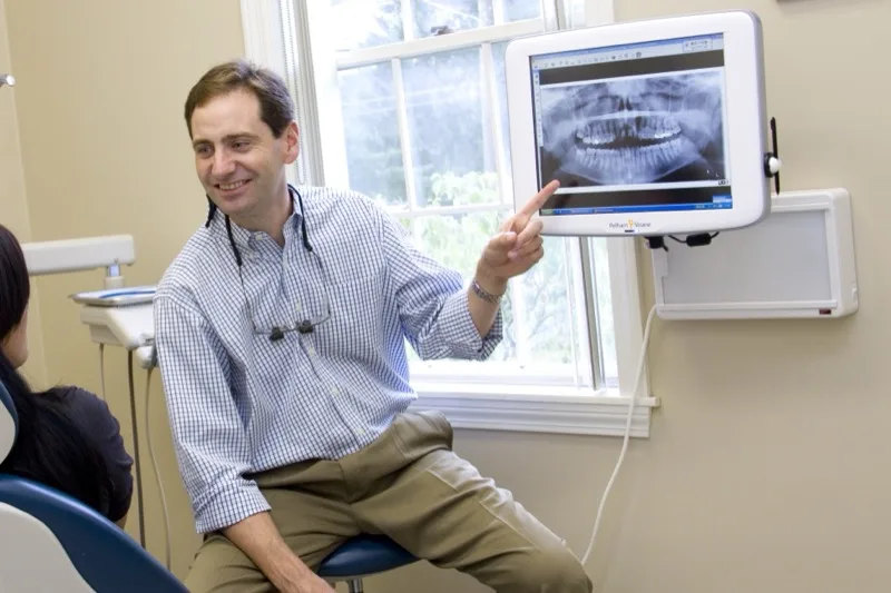 Dr. Gregory Bartek examining a patient at East Grove Family Dental